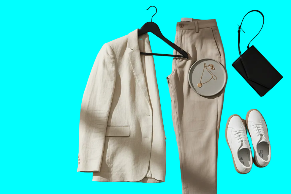 Fashionable outfit with beige blazer, pants, shoes, and handbag on a neutral background with text overlay.
